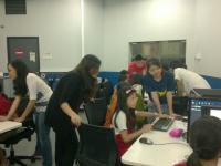 Friendly volunteers assisting young children in using Game Editor Friendly volunteers assisting young children in using Game Editor
